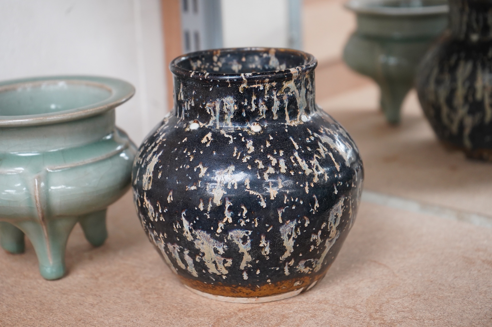 A Chinese celadon tripod censer and vase, largest 14cm high